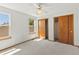 Well-lit bedroom with carpet, ceiling fan, and large windows at 14185 W Warren Cir, Lakewood, CO 80228