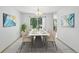 Elegant dining room with modern lighting, a large window, and stylish decor at 14185 W Warren Cir, Lakewood, CO 80228