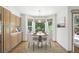 Bright breakfast nook with backyard view, built in cabinet, and hardwood floors at 14185 W Warren Cir, Lakewood, CO 80228