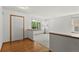 Bright entryway featuring hardwood floors transitioning to carpeted living area and a large window at 14185 W Warren Cir, Lakewood, CO 80228