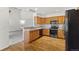 Well-maintained kitchen with stainless steel appliances, wood cabinets, and hardwood floors at 14185 W Warren Cir, Lakewood, CO 80228