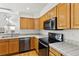 The kitchen features wooden cabinets, stainless steel appliances, and tiled countertops at 14185 W Warren Cir, Lakewood, CO 80228