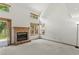 Spacious living room with a fireplace, large windows, and plenty of natural light at 14185 W Warren Cir, Lakewood, CO 80228