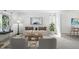 Bright living room features a neutral color palette, modern furniture, and large windows for ample natural light at 14185 W Warren Cir, Lakewood, CO 80228