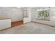 Bright living room featuring plush carpeting, a large window, and neutral decor at 14185 W Warren Cir, Lakewood, CO 80228