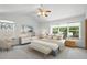Spacious main bedroom featuring bright windows, a ceiling fan, and neutral tones at 14185 W Warren Cir, Lakewood, CO 80228