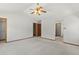 Bright main bedroom with white walls, carpet, and ceiling fan at 14185 W Warren Cir, Lakewood, CO 80228