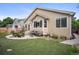 Spacious backyard with artificial turf, patio with outdoor seating, and mature landscaping at 6581 W Alamo Dr, Littleton, CO 80123