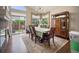 Bright dining room with large windows, chandelier, hardwood floors, and a dining table with seating at 6581 W Alamo Dr, Littleton, CO 80123