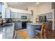 Kitchen featuring gray cabinets, granite countertops, a center island and stainless steel appliances at 6581 W Alamo Dr, Littleton, CO 80123