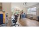 Open-concept living area with hardwood floors, a bar, dining area and views of the outdoor landscape at 6581 W Alamo Dr, Littleton, CO 80123