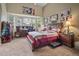 Cozy main bedroom with a large window, a desk, and a comfortable bed with decorative pillows at 6581 W Alamo Dr, Littleton, CO 80123