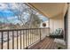 Private balcony with views of the parking area with lots of trees, furniture, and a wooden deck at 9680 Brentwood Way # 202, Broomfield, CO 80021