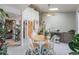 Bright dining area with a skylight, a light wood table with seating for four, and lots of surrounding greenery at 9680 Brentwood Way # 202, Broomfield, CO 80021