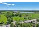 Scenic aerial view of the property, lake, nearby community, and distant city skyline at 3871 Moore St, Wheat Ridge, CO 80033