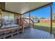 Spacious back deck leading to a grassy yard with a garage at 3871 Moore St, Wheat Ridge, CO 80033