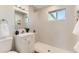 Bright bathroom features modern white vanity, updated fixtures, and a seamless walk-in shower at 3871 Moore St, Wheat Ridge, CO 80033