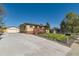 Quaint brick home with large driveway and front yard at 3871 Moore St, Wheat Ridge, CO 80033