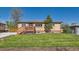 Charming single-story brick home with a cozy front porch and well-manicured lawn at 3871 Moore St, Wheat Ridge, CO 80033