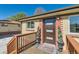 Inviting front entrance with a modern door, stylish potted plants, and a welcoming doormat at 3871 Moore St, Wheat Ridge, CO 80033