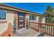Inviting front porch featuring a stylish door with glass inserts and decorative potted plants at 3871 Moore St, Wheat Ridge, CO 80033