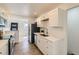 Modern kitchen with white cabinets, stainless steel appliances, quartz countertops, and wood-style floors at 3871 Moore St, Wheat Ridge, CO 80033