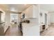 Modern kitchen with white cabinets, stainless steel appliances, and wood-style floors at 3871 Moore St, Wheat Ridge, CO 80033