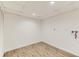 Minimalist laundry room with wood floors, white walls, and appliance hookups at 3871 Moore St, Wheat Ridge, CO 80033