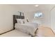 Bright main bedroom with hardwood floors, a gray headboard, and plenty of natural light at 3871 Moore St, Wheat Ridge, CO 80033