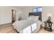Cozy main bedroom with hardwood floors, a gray headboard, and a side table at 3871 Moore St, Wheat Ridge, CO 80033
