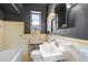 Bathroom with retro tile, dark walls and a pedestal sink at 1321 E 10Th Ave # 4, Denver, CO 80218