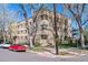 Brick apartment building on a corner lot with mature trees and a street view showcasing the architecture at 1321 E 10Th Ave # 4, Denver, CO 80218