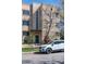 Brick building exterior with a well-manicured lawn, lovely green trees and a bright white vehicle at 1321 E 10Th Ave # 4, Denver, CO 80218