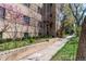 Apartment building exterior with lush landscaping, flowering trees and a well-maintained walkway at 1321 E 10Th Ave # 4, Denver, CO 80218