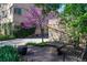 A beautiful outdoor area has garden, benches, pavers, and a blossoming tree in the apartment courtyard at 1321 E 10Th Ave # 4, Denver, CO 80218