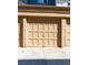 Close-up view of a tan garage with several square recessed panels and dark hardware at 1321 E 10Th Ave # 4, Denver, CO 80218