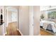 View of the hallway leading to bedroom with hardwood floors and archway detail at 1321 E 10Th Ave # 4, Denver, CO 80218