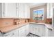 Quaint kitchen with vintage charm, featuring white cabinets, colorful tile countertops, and a window view at 1321 E 10Th Ave # 4, Denver, CO 80218
