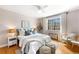 Bright main bedroom featuring hardwood floors, ceiling fan, and a large window at 1321 E 10Th Ave # 4, Denver, CO 80218