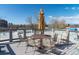 Enjoy outdoor dining on this rooftop patio with dining table, umbrella, and scenic city views at 1321 E 10Th Ave # 4, Denver, CO 80218