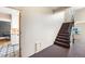Bright staircase featuring patterned carpet, neutral walls, and natural light from windows at 1321 E 10Th Ave # 4, Denver, CO 80218