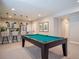 Finished basement features a billiard table and wet bar with pendant lighting and stainless steel refrigerator at 18940 E 96Th Pl, Commerce City, CO 80022