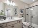 Modern bathroom features a walk-in shower, framed mirror, vanity with storage, and white countertops at 18940 E 96Th Pl, Commerce City, CO 80022