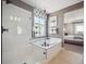 Luxurious bathroom featuring a glass shower, soaking tub, and stylish tile work at 18940 E 96Th Pl, Commerce City, CO 80022
