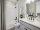 Modern bathroom with white tiled shower and black fixtures and countertop at 18940 E 96Th Pl, Commerce City, CO 80022