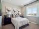 Cozy bedroom with neutral colors, stylish decor, and a large window for natural light at 18940 E 96Th Pl, Commerce City, CO 80022