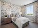 Charming bedroom with decorative wall coverings and ample natural light from the large window at 18940 E 96Th Pl, Commerce City, CO 80022