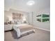 Comfortable bedroom features neutral tones, decorative wall art, side tables with lamps, and a window with curtain at 18940 E 96Th Pl, Commerce City, CO 80022