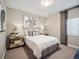 Cozy bedroom with neutral tones, decorative wall art, side tables, lamps and a window with privacy curtain at 18940 E 96Th Pl, Commerce City, CO 80022