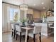 Cozy dining area with a stylish table setting that sits adjacent to a modern kitchen at 18940 E 96Th Pl, Commerce City, CO 80022
